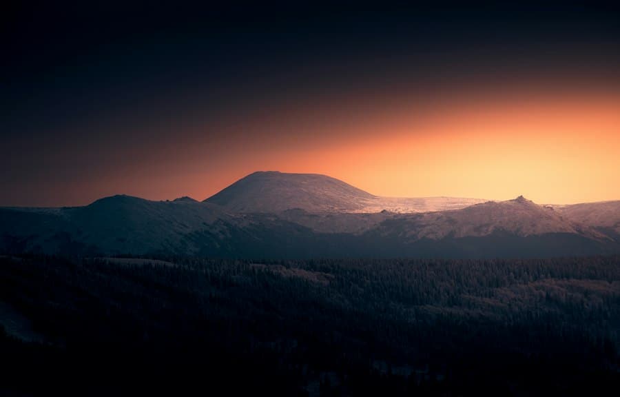 Sunset glow over a silhouetted mountain ridge